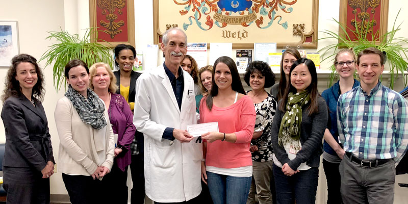 Tracie Kurczy-Lussier presents a check for nearly $6,000 to Dr. Stephen Salloway and staff at the Memory and Aging Program at Butler Hospital in Rhode Island to support groundbreaking Alzheimer's research being done by the program.