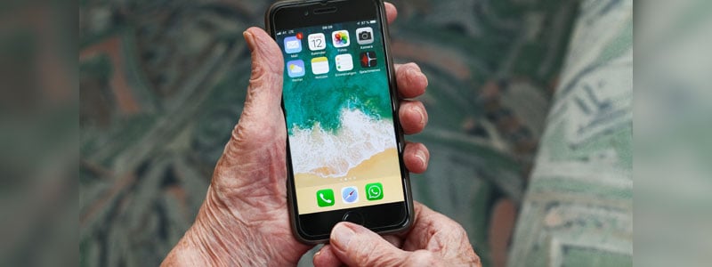 Older person's hands holding smartphone